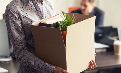 fired employee leaving office with things in a box