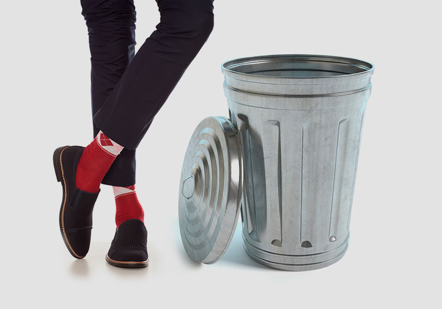 legs beside trash can