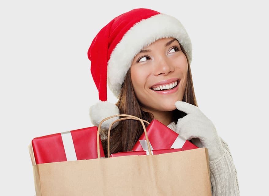 smiling lady wearing Christmas hat