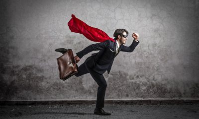 businessman with cape running
