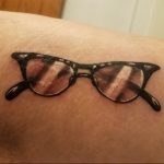 eyewear tattoo on arm