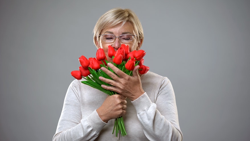 elderly-smelling-flowers